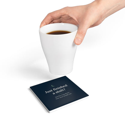 Hand setting a mug down on the square Cove coaster