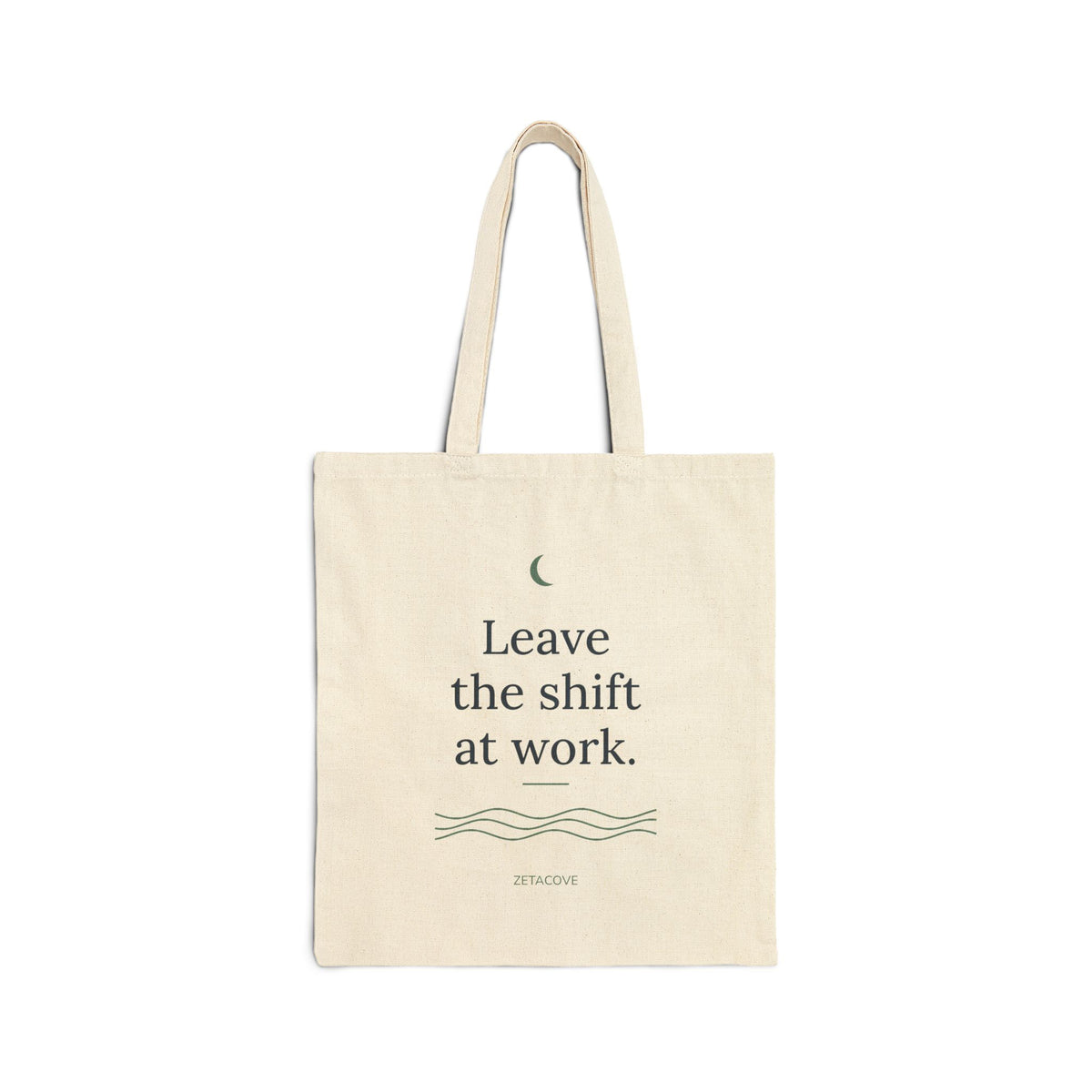 Cove natural canvas tote bag printed with "Leave the shift at work." in navy with a sage moon and waves