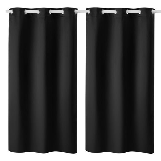 Two black Cove blackout curtain panels hanging on a curtain rod
