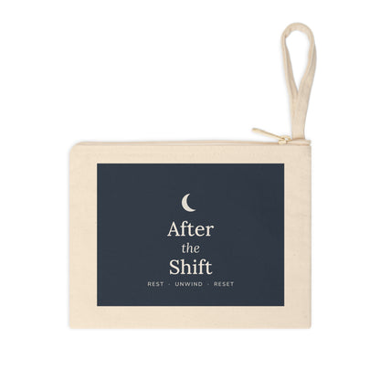 Natural canvas zipper pouch with a navy "After the Shift" panel and wrist strap