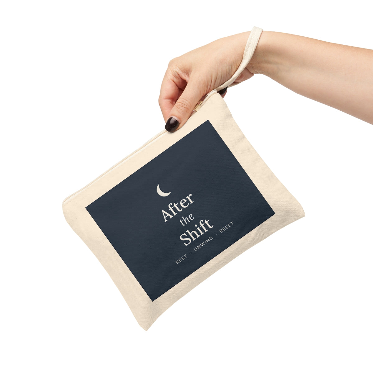 The zipper pouch held by its strap, angled