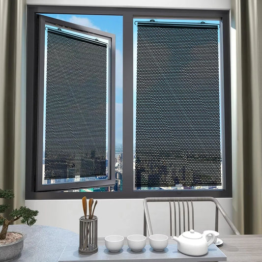 Two Cove suction-cup window shades dimming a bright window